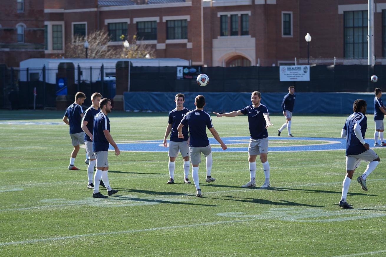 group of men playing football on field